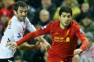 LIVERPOOL, ENGLAND - Saturday, December 22, 2012: Liverpool's Luis Alberto Suarez Diaz in action against Fulham's Giorgos Karagounis during the Premiership match at Anfield. (Pic by David Rawcliffe/Propaganda)